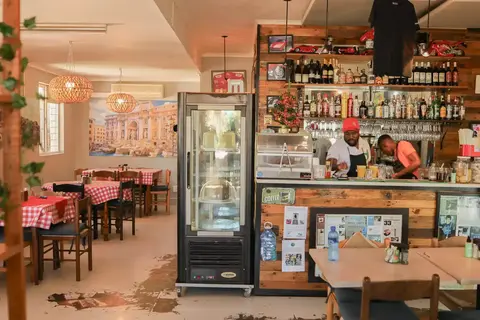 Inside Dario's Café: the coffee bar, cake fridge and dining room on Main Road, Hout Bay